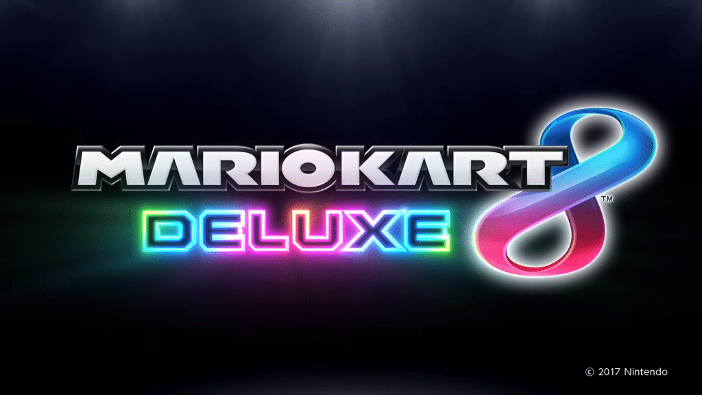 logo ufficiale di mario kart 8 deluxe con scritta luminosa e sfondo scuro.