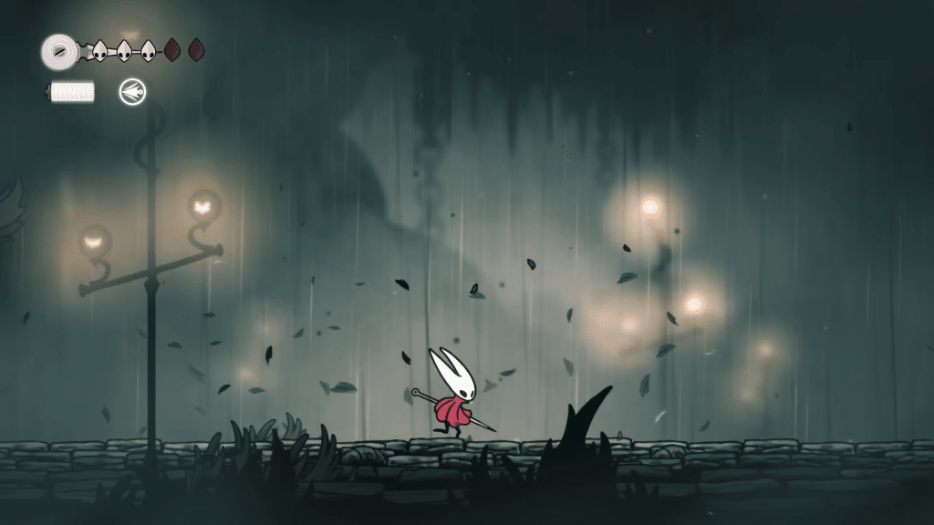 hornet cammina sotto la pioggia in una zona cupa di hollow knight: silksong.