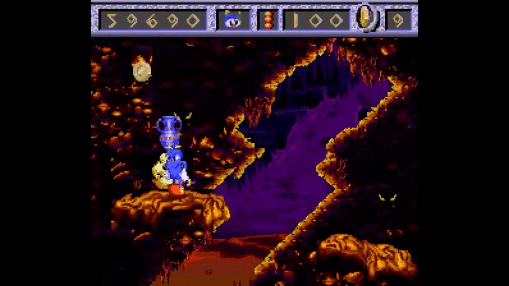 screenshot di izzy’s quest for the olympic rings ambientato in una caverna con pareti rocciose viola e arancioni.