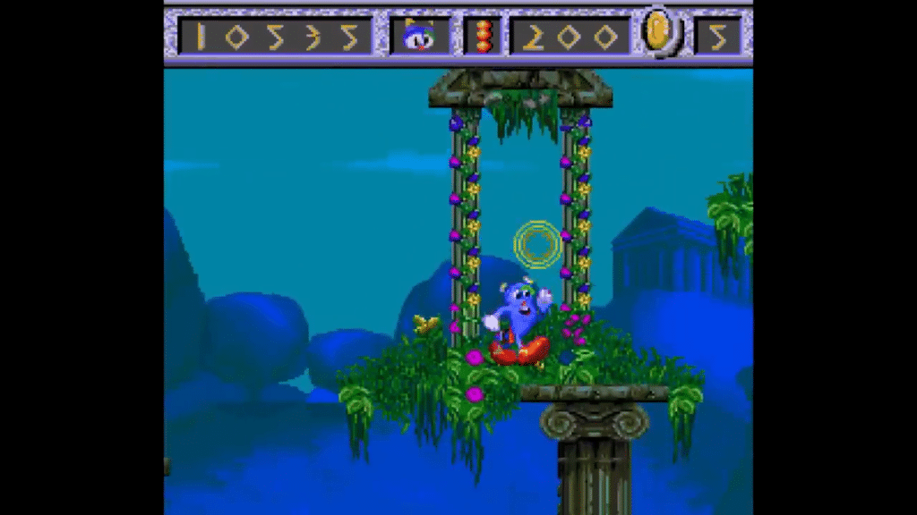 screenshot di izzy’s quest for the olympic rings con izzy che raccoglie un anello dorato su una struttura a colonne in un livello acquatico